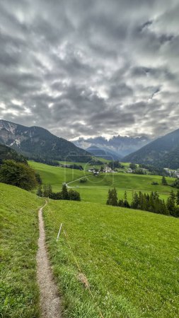Photo for Santa Maddalena, Val di Funes-Alpine charm, iconic church, meadows, forest trails, Tirolean allure-your starting point for panoramic hikes in a picturesque haven - Royalty Free Image