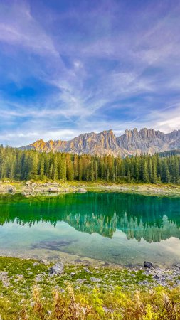 Photo for Lago di Carezza,Elevation 1,519m, an alpine masterpiece with emerald waters, cradled by spruce trees, framed by the majestic Dolomites,a fairy tale painted in nature's enchanting strokes - Royalty Free Image