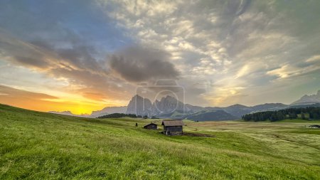 Photo for Alpe di Siusi graced by morning light, its golden hue cloaking the Dolomites, paints Italy's vivid dawn portrait - Royalty Free Image
