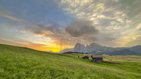 Photo for Morning's first light weaves gold over Alpe di Siusi, the Dolomites standing majestic in Italy's ethereal dawn - Royalty Free Image