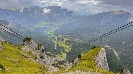 Photo for A gondola ascends from Ortisei to Seceda peak, offering a breathtaking journey over the picturesque Val Gardena within Italy's Dolomites - Royalty Free Image