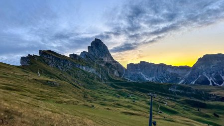 Photo for Sunrise bathes Seceda in warm light, autumn colors burst,a stunning Dolomite tableau captured in Italy - Royalty Free Image