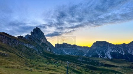 Photo for Verdant slopes meet rugged peaks under a clear sky in the tranquil Dolomites. - Royalty Free Image