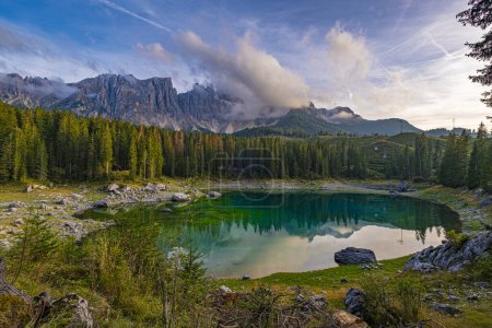 Photo for Lago di Carezza, resting at 1,519m, an alpine wonder with emerald waters, embraced by spruce trees, framed by the majestic Dolomites, a fairy tale unfolding in nature's enchanting panorama - Royalty Free Image