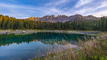 Photo for Lago di Carezza, emerald waters, mystical Spruce forests, Latemar mountain views. A picturesque gem in South Tyrol and the Dolomites' favorite - Royalty Free Image