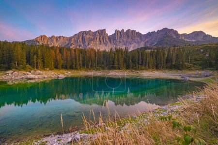 Photo for Lago di Carezza,Emerald waters, misty forests, Latemar views, an enchanting Alpine canvas. A beloved South Tyrol gem, guide for essential tips - Royalty Free Image