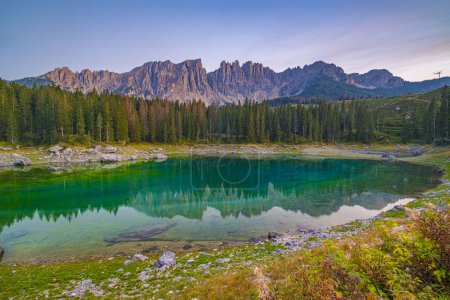 Photo for Lago di Carezza, Emerald waters, misty forests, Latemar views, an Alpine masterpiece. Beloved in South Tyrol, explore the guide for essential tips - Royalty Free Image