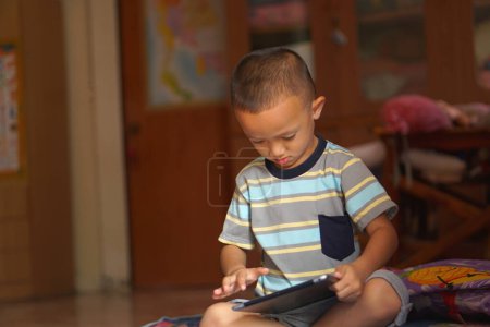 Téléchargez les photos : Garçon ennuyé jouer à des jeux informatiques - en image libre de droit