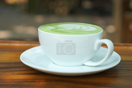 Photo for Hot green tea. Flower bubbles in a glass. - Royalty Free Image