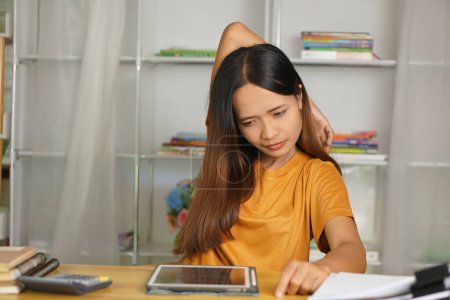 Photo for Asian woman working from home having pain from sitting for a long time - Royalty Free Image