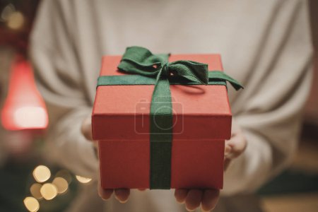 Photo for The person holding festive present box in her hands for send happiness greeting season - Royalty Free Image