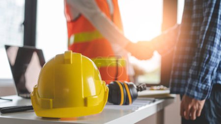 Foto de Construction worker and contractor. Client shaking hands with team builder in renovation site. - Imagen libre de derechos