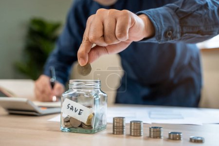 Photo for The person putting coin into piggy bank to save money and invest for growth in future. - Royalty Free Image