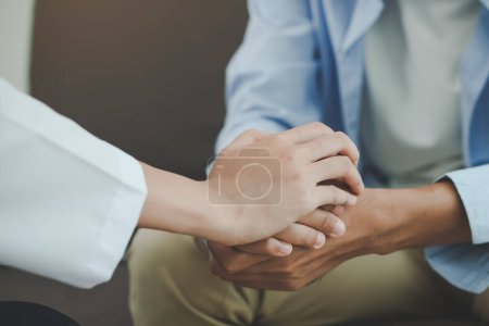 Foto de Psicólogo tocar las manos del paciente durante la terapia de conversación estresado salud mental en el consultorio - Imagen libre de derechos