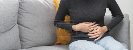 Photo for Close up woman suffering stomach pain from food poisoning. - Royalty Free Image