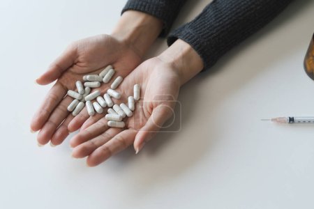 Photo for Close up hand of young women. Stressed female taking drug overdose. - Royalty Free Image