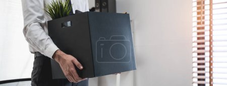 Photo for Lay off workers. Banner size closes up hands of usinessman holding box of stuff to leave office after fired from work. - Royalty Free Image
