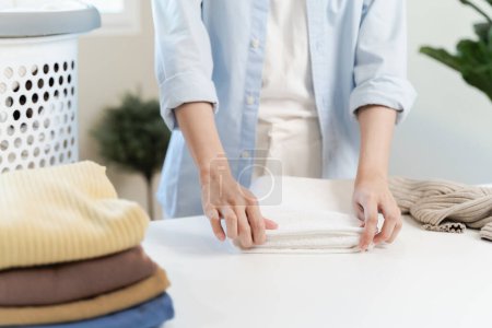 Photo for Laundry household work concept, asian woman working on fresh clean clothes. - Royalty Free Image
