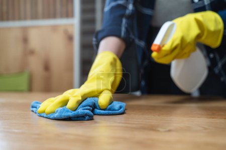 Photo for Asian woman cleaning the table surface with towel and spray detergent - Royalty Free Image