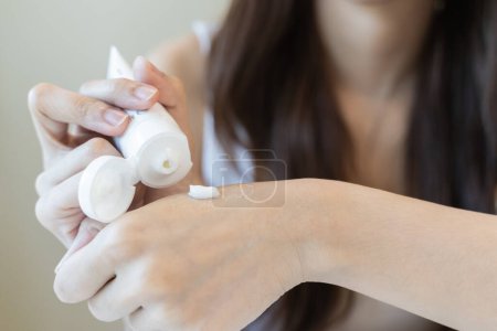 Foto de Woman using moisturizer cream applying hand - Imagen libre de derechos