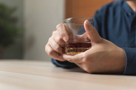 Photo for Close up hand man holding a glass of whisky - Royalty Free Image