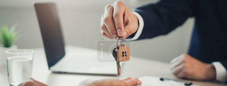 Photo for Close up view hand of property realtor landlord giving key house to buyer tenant. - Royalty Free Image