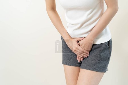 Photo for Woman having painful lower stomach and hands holding pressing her crotch lower abdomen - Royalty Free Image