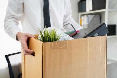 Photo for Lay off workers. Banner size closes up hands of usinessman holding box of stuff to leave office after fired from work. - Royalty Free Image