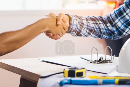 Photo for Architect contractor shaking hands with client after seal a deal to renovate building. - Royalty Free Image