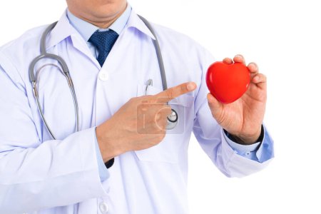 Foto de Check-up your heart disease at hospital. Male doctor pointing at red heart isolated on white background. - Imagen libre de derechos