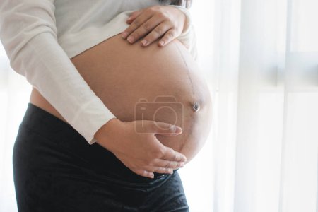 Photo for Mother countdown for baby birth. Pregnant woman touching on her belly. - Royalty Free Image