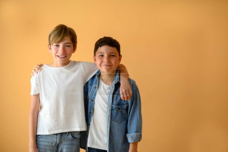 Porträt zweier Kinder, Freunde, die einander halten und auf dem Hintergrund mit Kopierraum lächeln