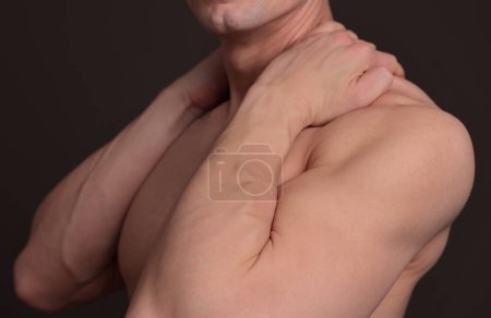 Photo for Man with back and neck pain. Muscular male body. Sport exercising injury prevention convept - Royalty Free Image