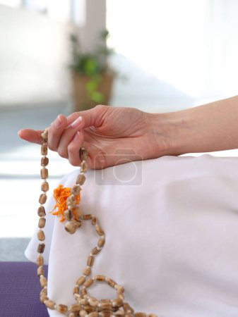 Photo for Woman hand holding Rosary beads close up. Yoga, Meditation, Holistic wellness concept. - Royalty Free Image
