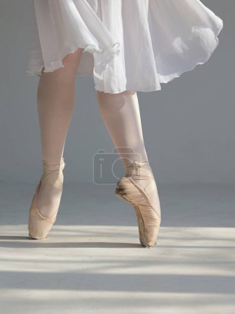 Photo for Ballerina dancing , standing in pointe position. Close up on legs and old ballet shoes. Talent, Determination and Motivation concept. - Royalty Free Image