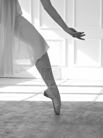 Photo for Beautiful ballerina dancing, close up on of hand and leg Femininity , Grace and Tenderness concept. Black and White image - Royalty Free Image
