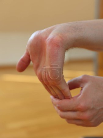 Photo for Man doing wrist stretching exercises close up - Royalty Free Image
