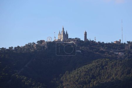 Photo for Tibidabo parc on the hill from a far, Barcelona, Spain - Royalty Free Image