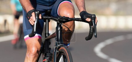 Photo for Cyclist in the race on a road bike handlebar detail - Royalty Free Image