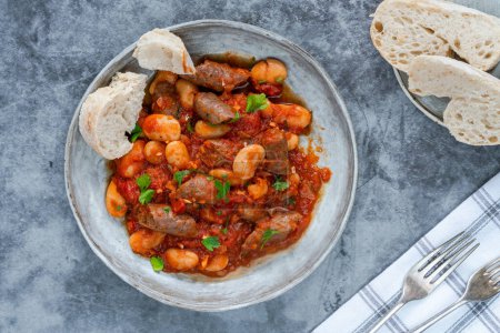 Photo for Beef chipolatas and bean casserole with crusty bread - Royalty Free Image