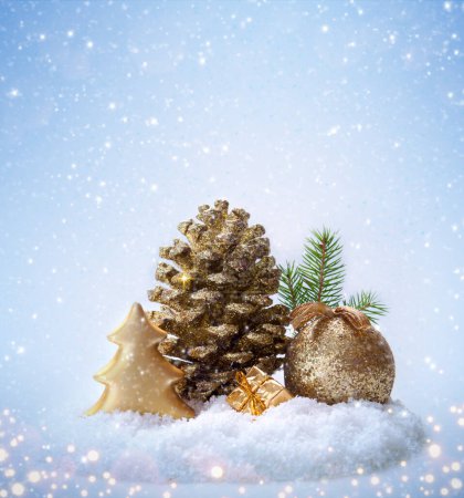 Photo for Christmas golden decoration and fir tree isolated on blue blur background. - Royalty Free Image