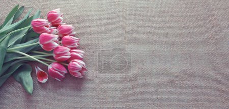 Photo for Row of tulips on cloth background with space for message. Mothers Day background. - Royalty Free Image