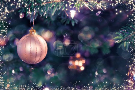 Photo for Christmas tree branch with golden ball and blur background. - Royalty Free Image