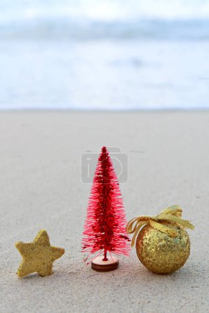 Photo for Merry Christmas ball and decorations on the white Caribbean sand. - Royalty Free Image
