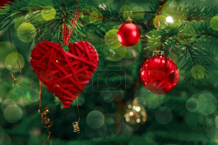 Photo for Red heart hang on a fir tree branch. - Royalty Free Image