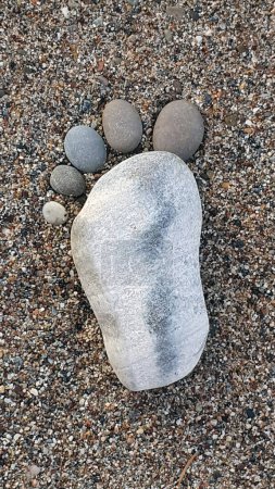 Photo for The foot made up of stones on a sandy background.Spa background. - Royalty Free Image