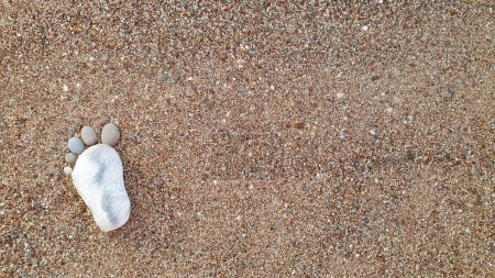 Photo for The foot made up of stones on a sandy background.Spa background. - Royalty Free Image
