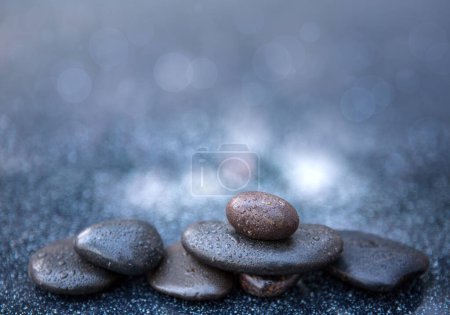 Photo for Black spa stones on a gray background, space for a text. - Royalty Free Image