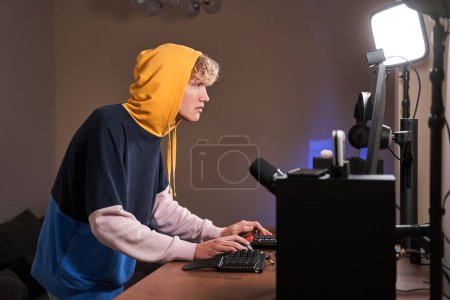 Photo for Thye guy is a gammer preparing his device for gamming - Royalty Free Image