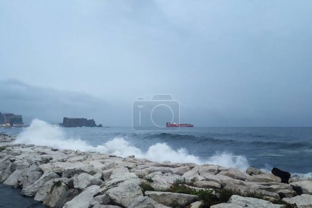 Photo for After months of heat and drought, heavy rains and thunderstorms hit the whole of Italy and Southern Italy, creating damage, inconvenience to the population and flooding.Waves break on the seafront of Mergellina with the Castel dell'Ovo. - Royalty Free Image